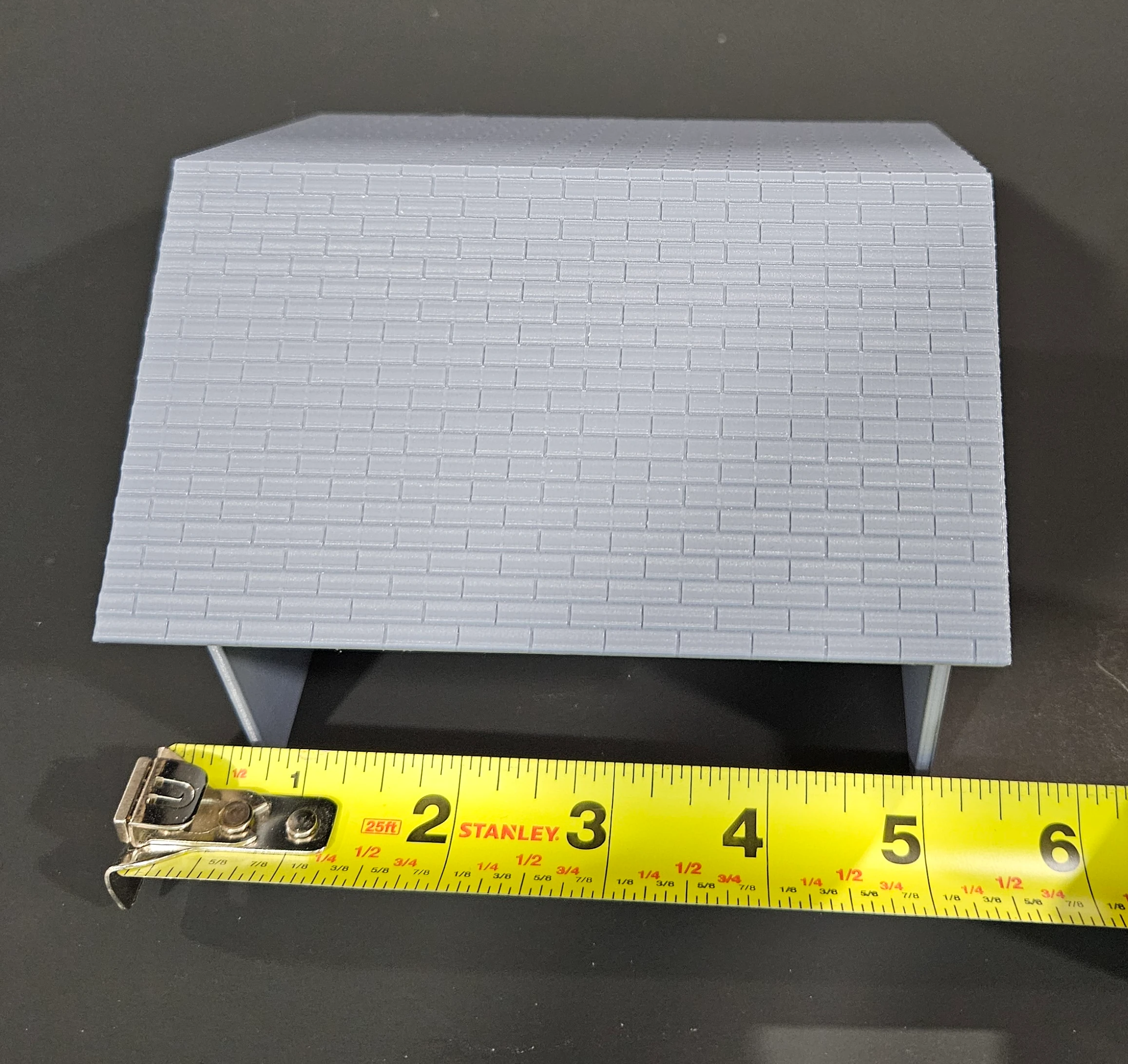 HO scale livery stable displayed in a scenic setting